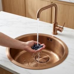 copper-kitchen-sink-with-faucet-and-blueberries